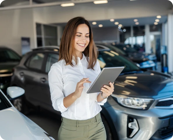 Female browsing tablet in dealership
